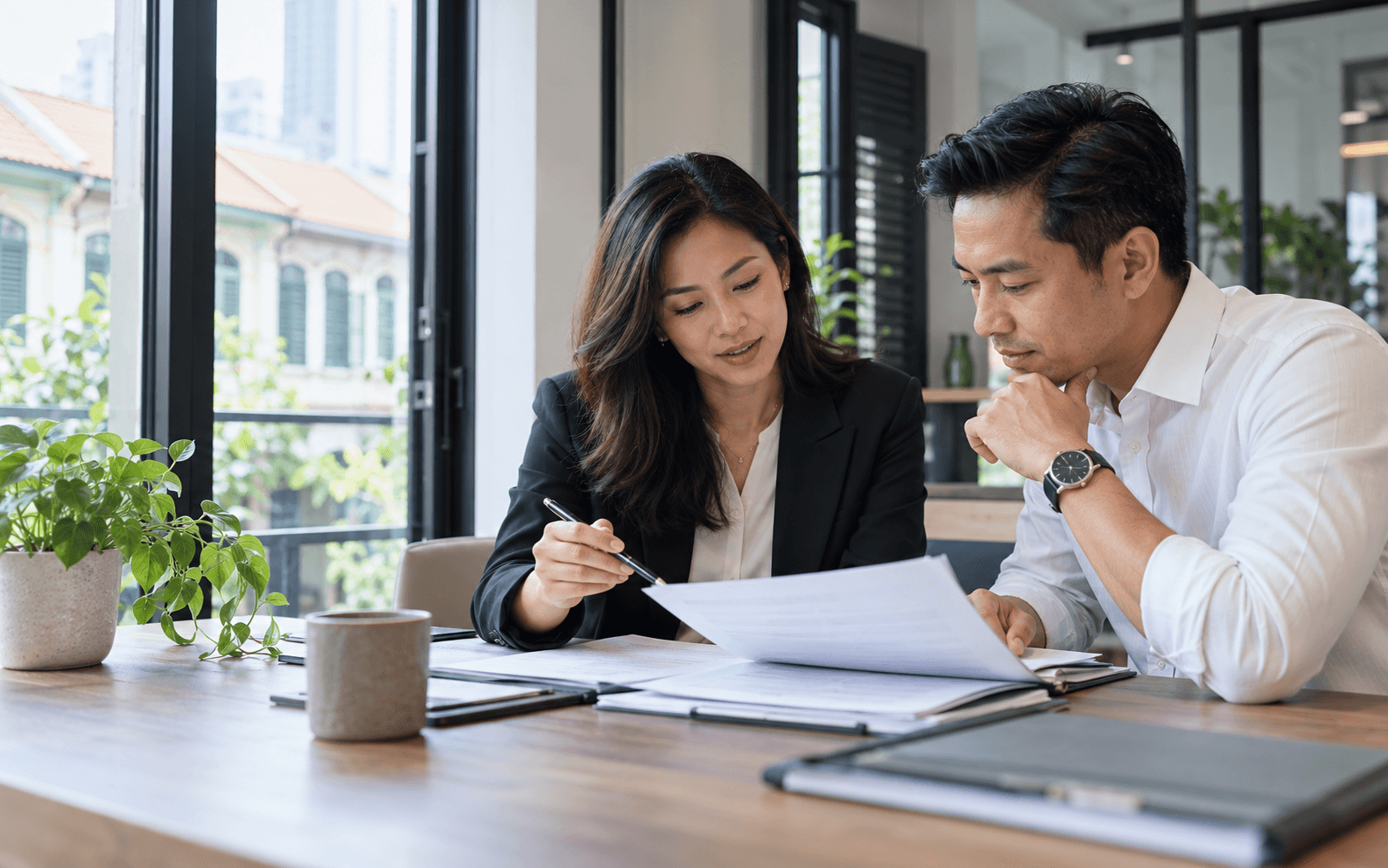 A corporate secretarial professional reviewing company documents with a business owner